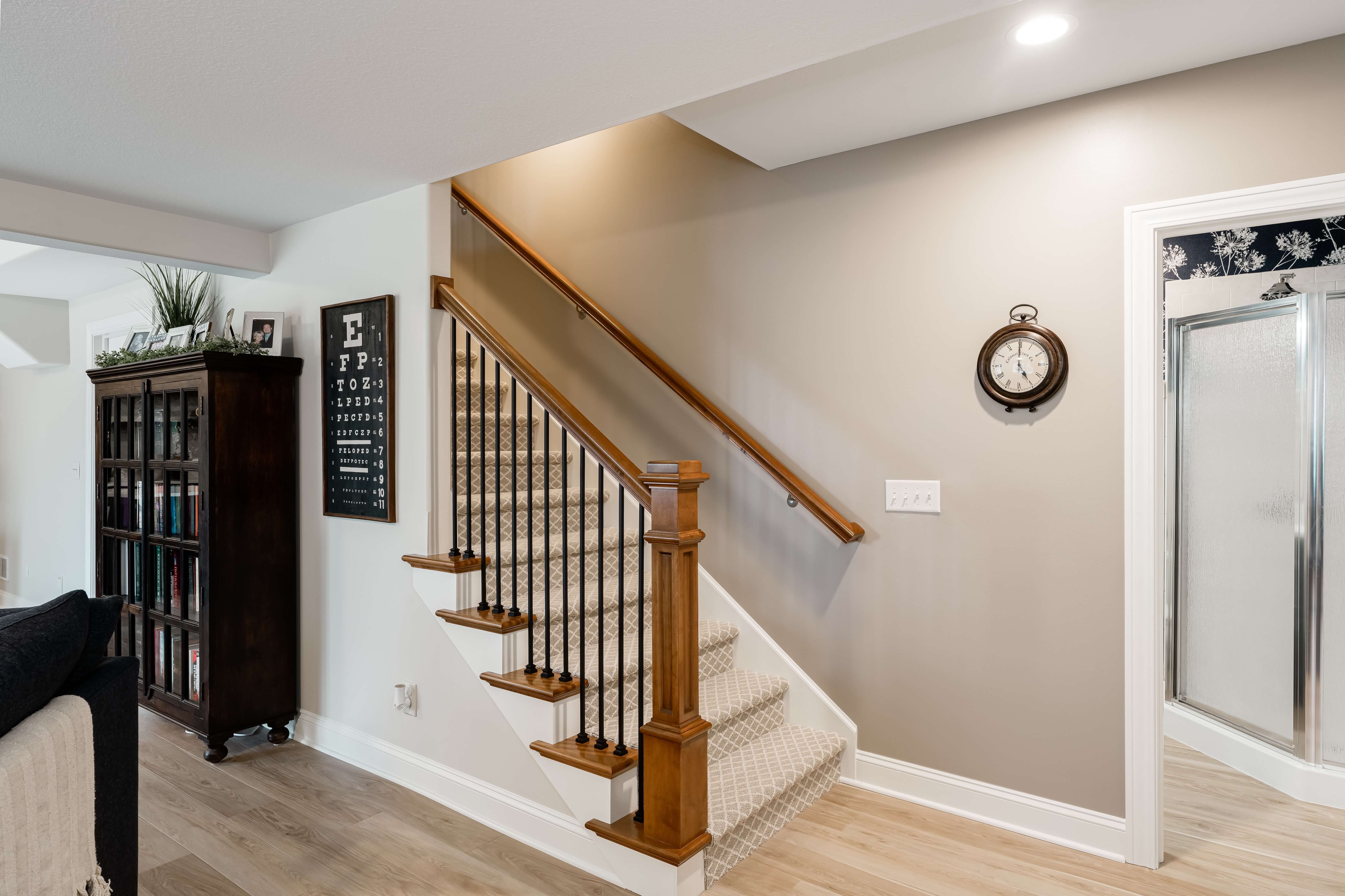 Basement remodel stairwell leading into bathroom and dining area