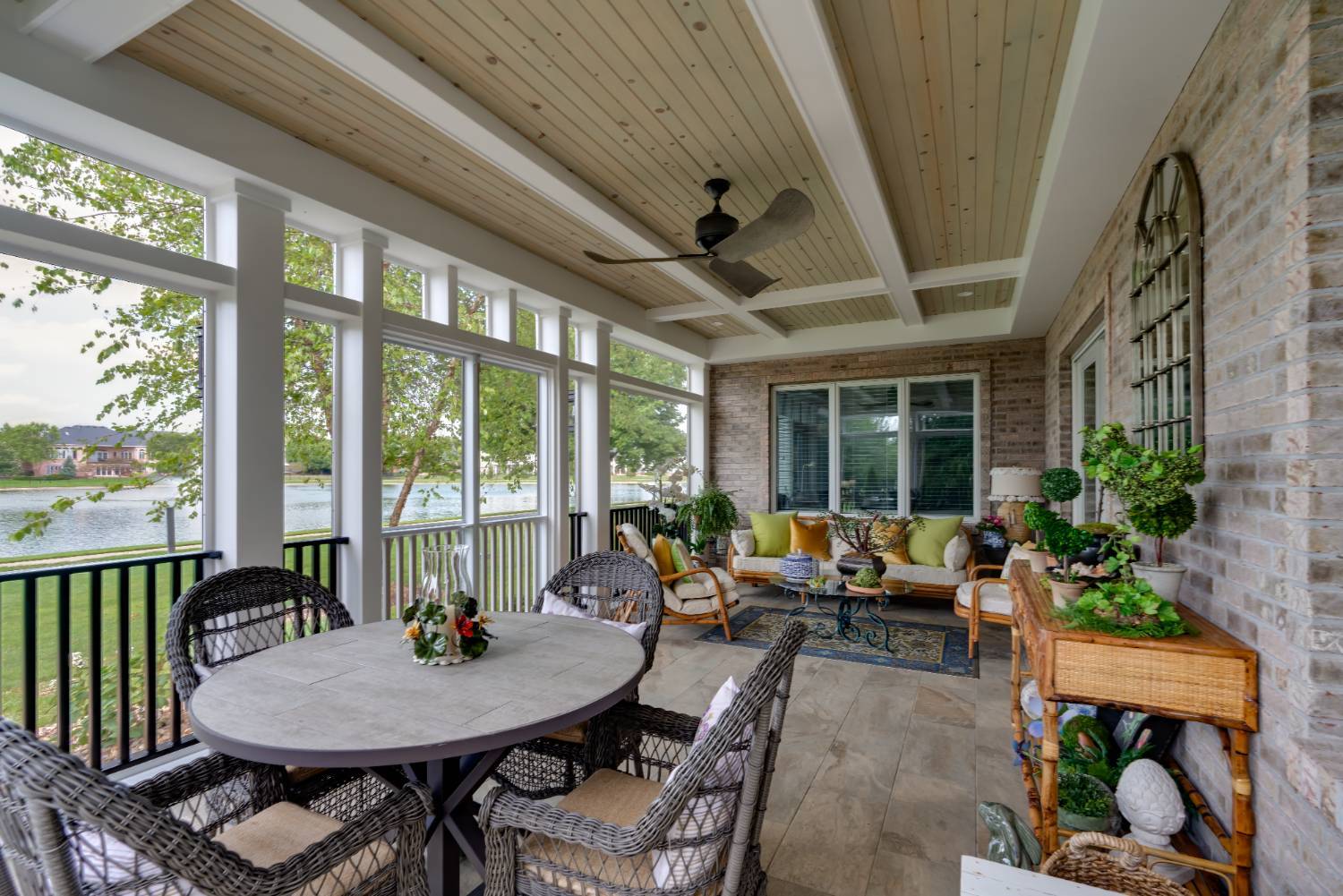 enclosed sunroom porch with seating and decor by Landmark Construction in Bloomington, IL-optimized