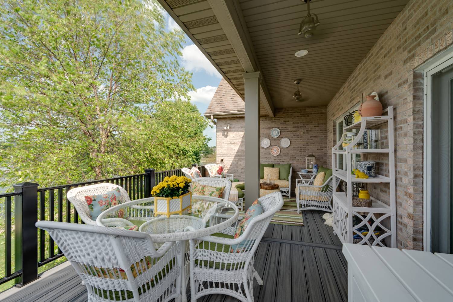 outdoor living deck with dining set and railing overlooking trees by Landmark Construction in Bloomington, IL-optimized