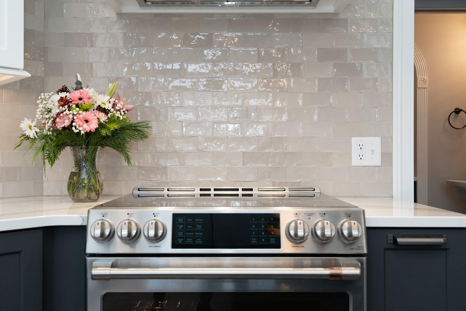 kitchen remodel with dark cabinetry and white granite countertops